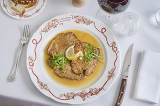 Veal dish on laid table