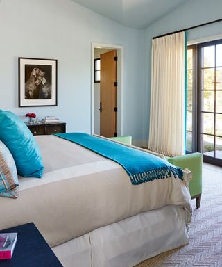 neutral bedroom with turquoise accents, matching trim on drapes, artwork, MDG Blue Guest(Alex Burg)