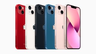 A line of iPhone 13 phones in various colors.