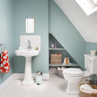 attic bathroom with blue wall and white flooring