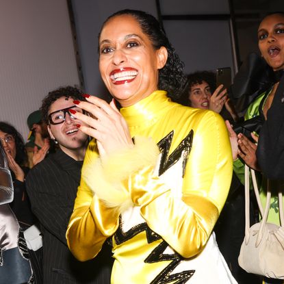 Tracee Ellis Ross backstage at the Marni Fall 2025 runway show wearing an electric yellow dress with beaded zig zag stripes