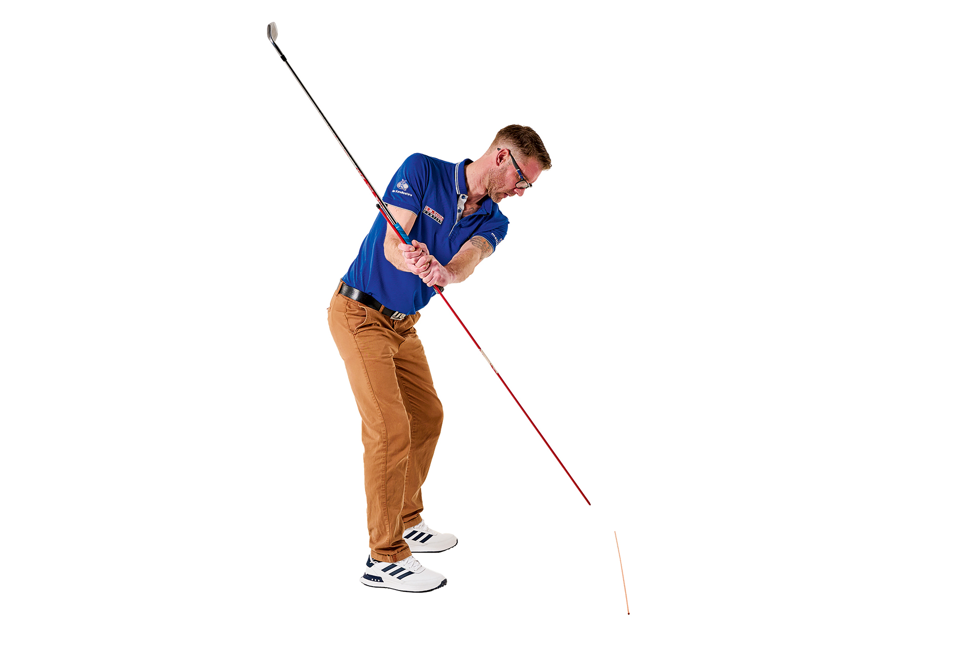 Tom Motley demonstrating the golf swing plane mirror drill in the downswing, with the alignment stick still pointing down towards the floor