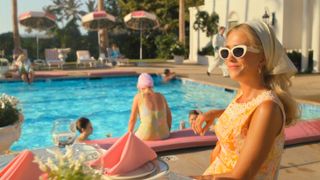 Kristen Wiig relaxes by the pool in Palm Royale