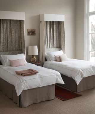 An example of bed ideas showing twin beds with canopies and white bedding