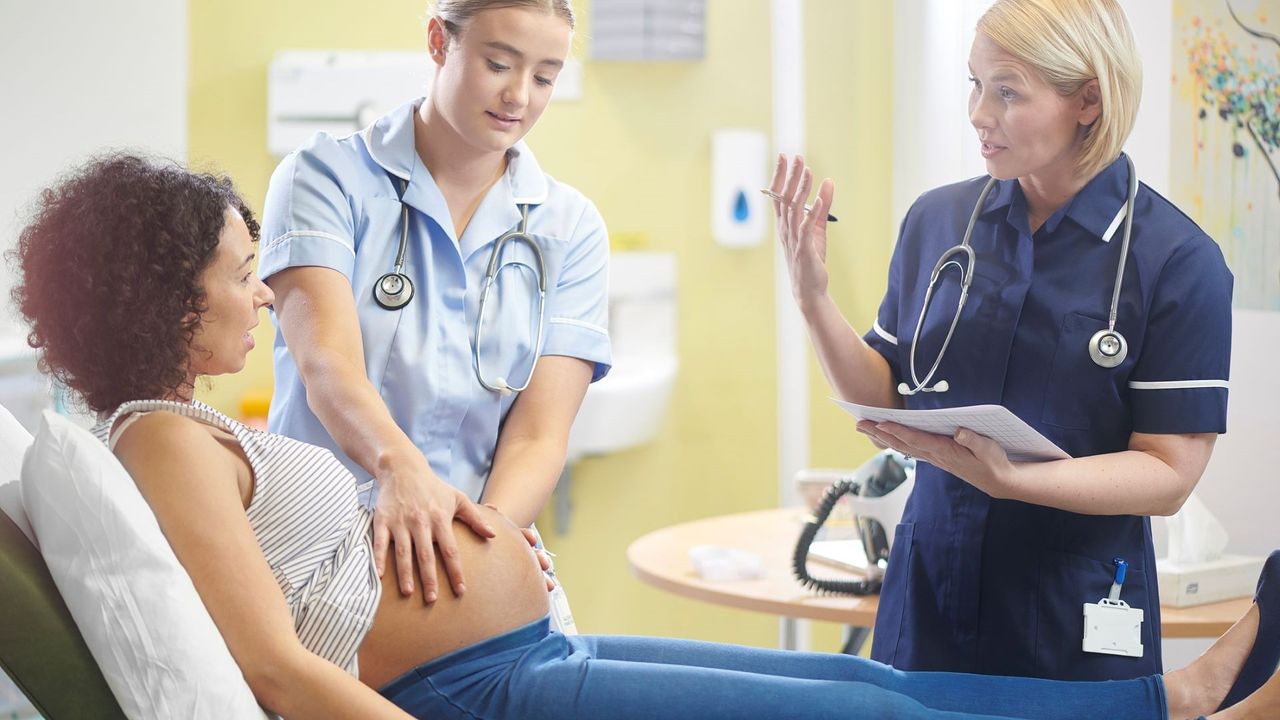 Membrane sweep illustrated by a Midwife and pregnant woman