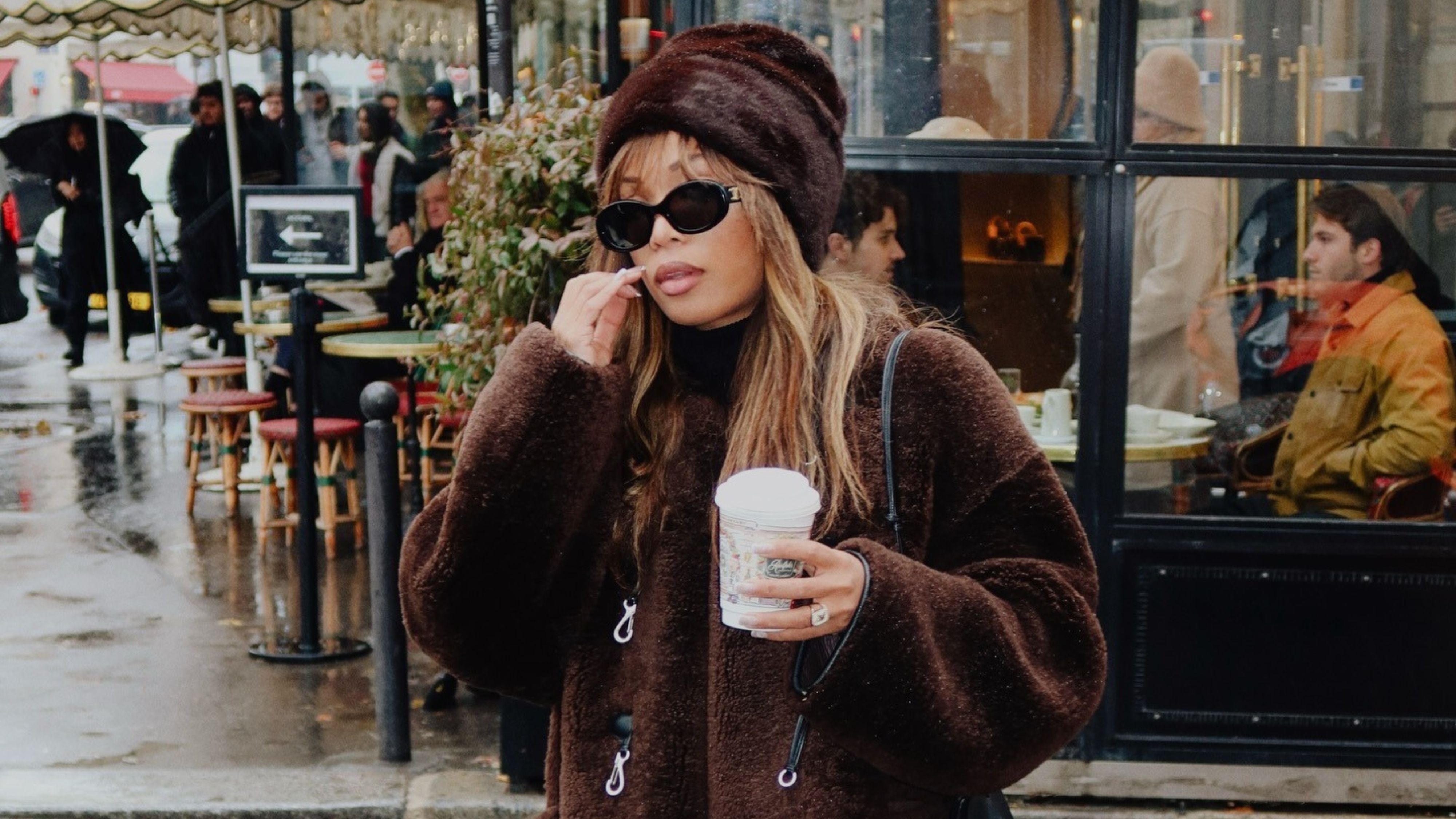 @slipintostyle wearing a faux fur hat, a French girl winter wardrobe staple.