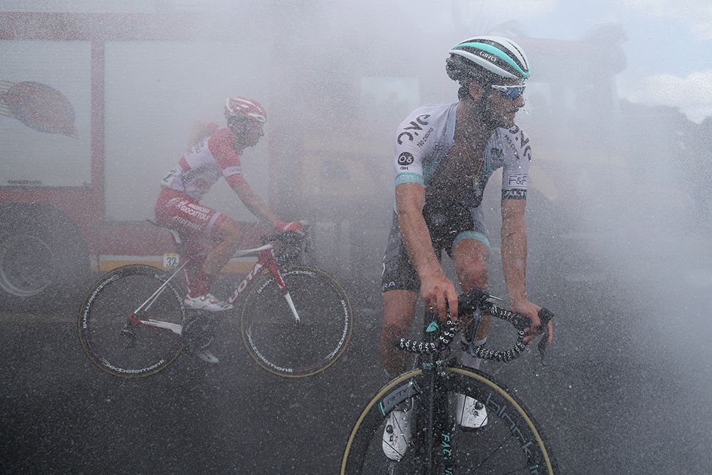 Water sprays the riders at the finish