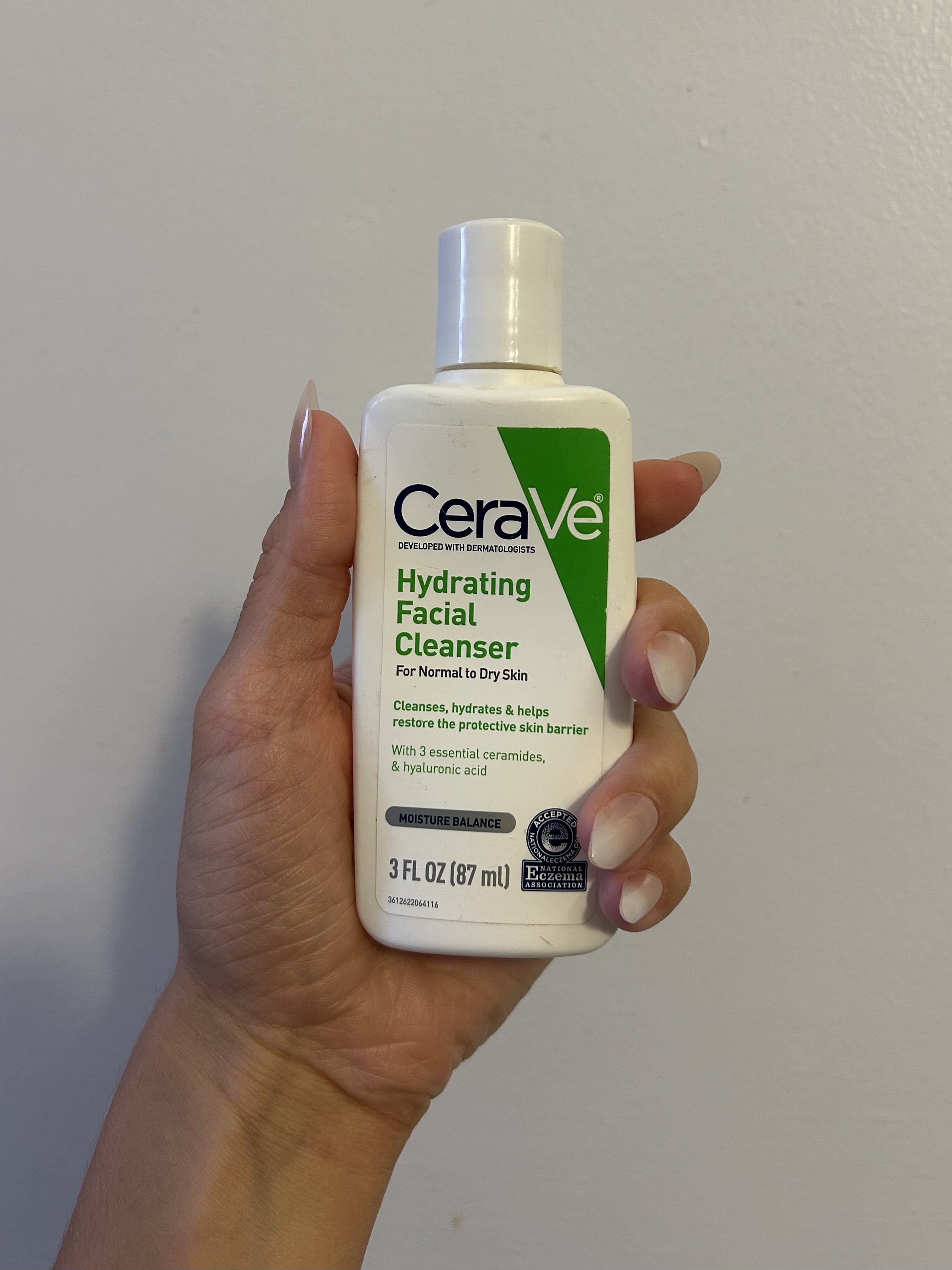 Alyssa holding the CeraVe cleanser.