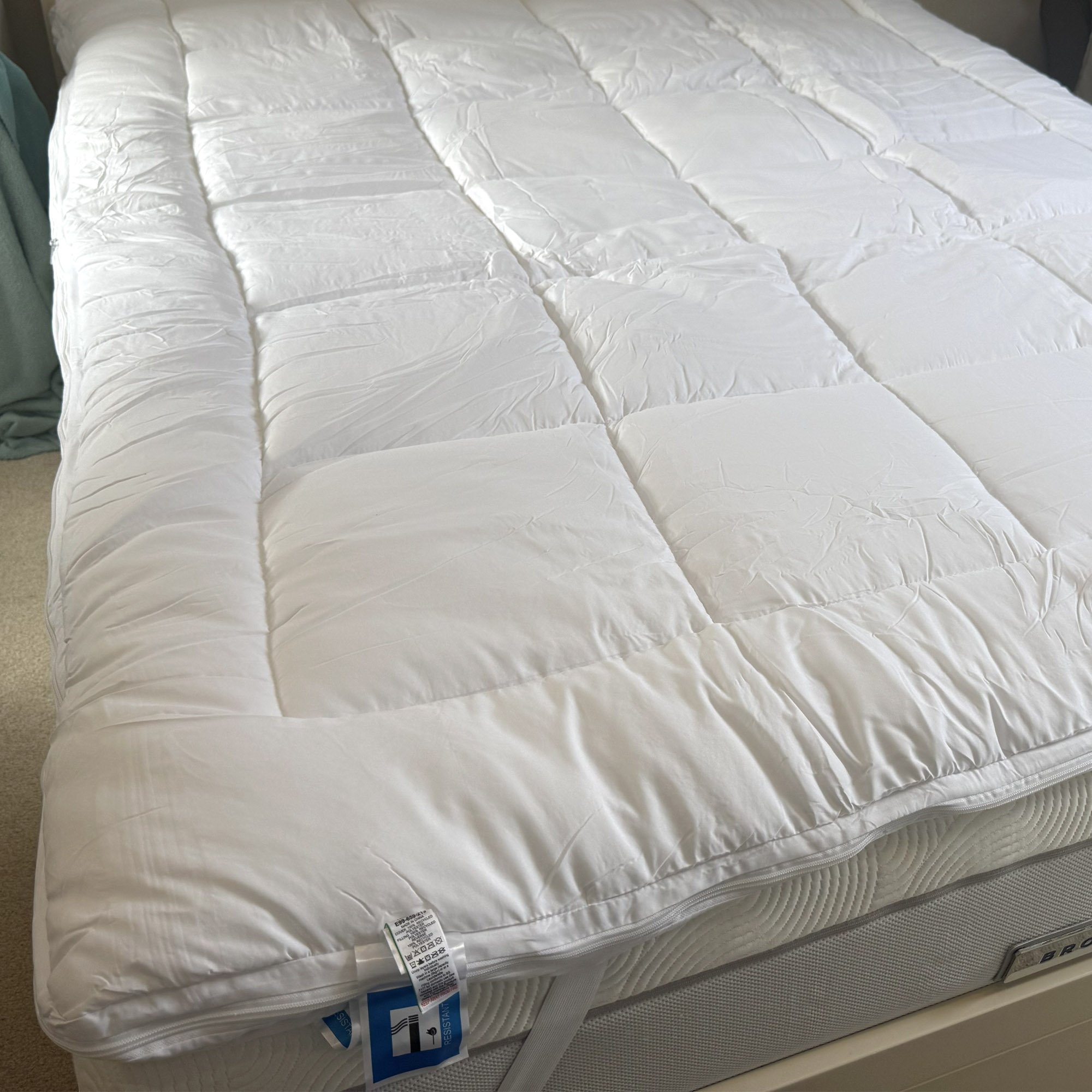 Next White Sleep In Comfort Dual Layer Mattress Topper being tested on a bed at home