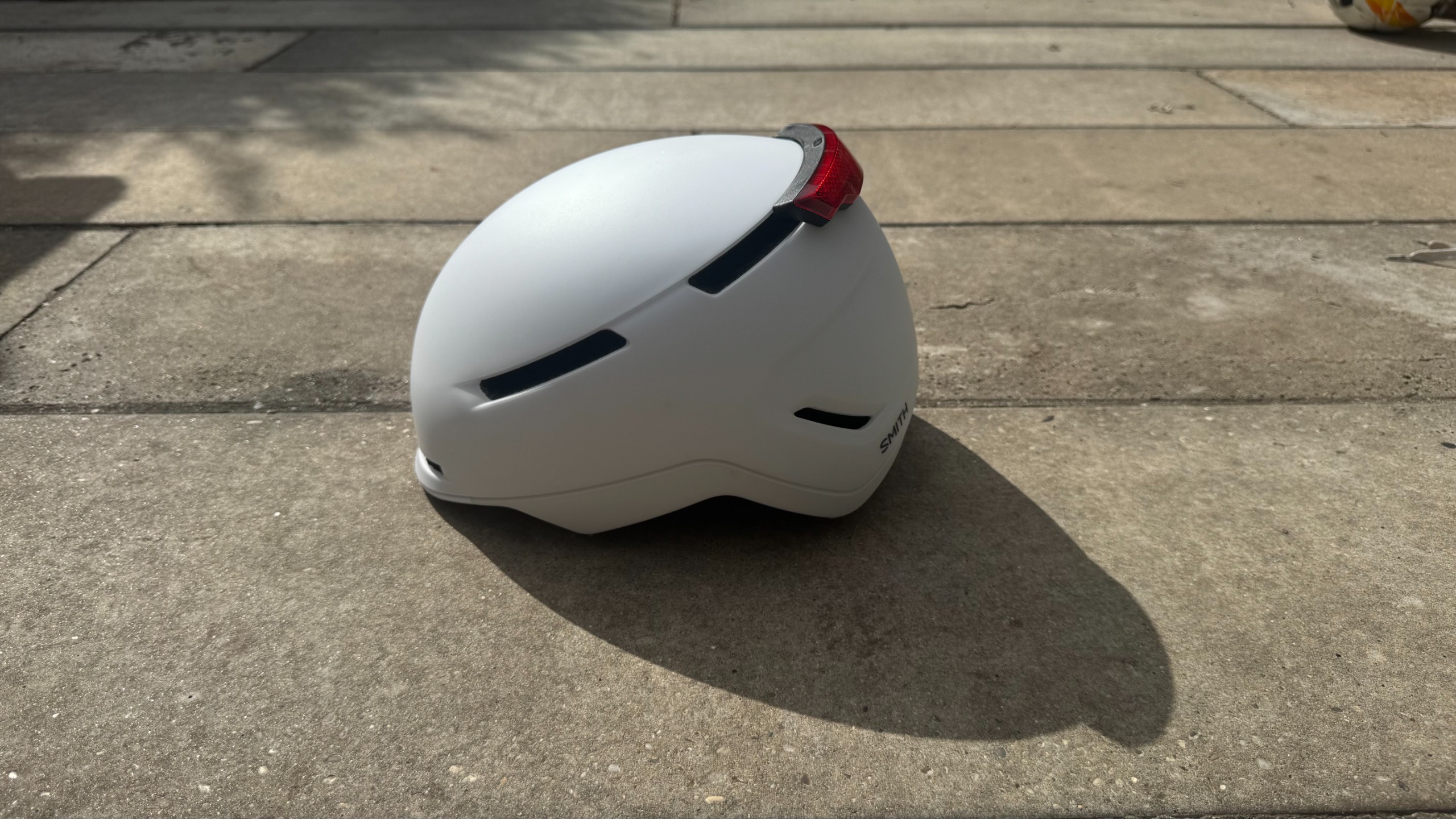 A Smith Despatch helmet on a paved surface