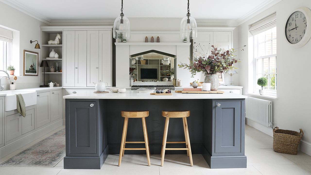 an open plan neutral shaker-style kitchen with a dark coloured kitchen island with a breakfast bar