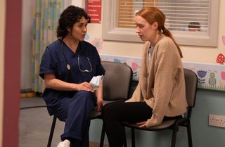 A distressed Chloe Harris sits with a doctor