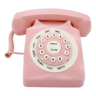 Pink vintage telephone on white background