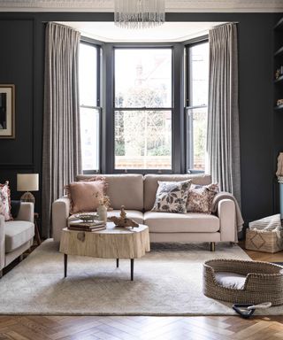 colors that go with light grey/living room with charcoal walls and window, light grey drapes, taupe couches, wooden coffee table, blush pink cushions, rug, herringbone flooring