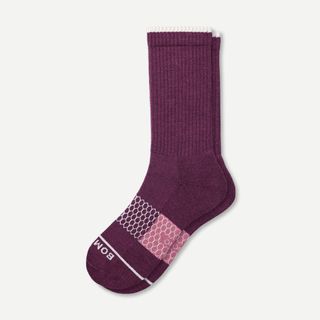 A pair of purple and pink Bombas merino wool calf socks