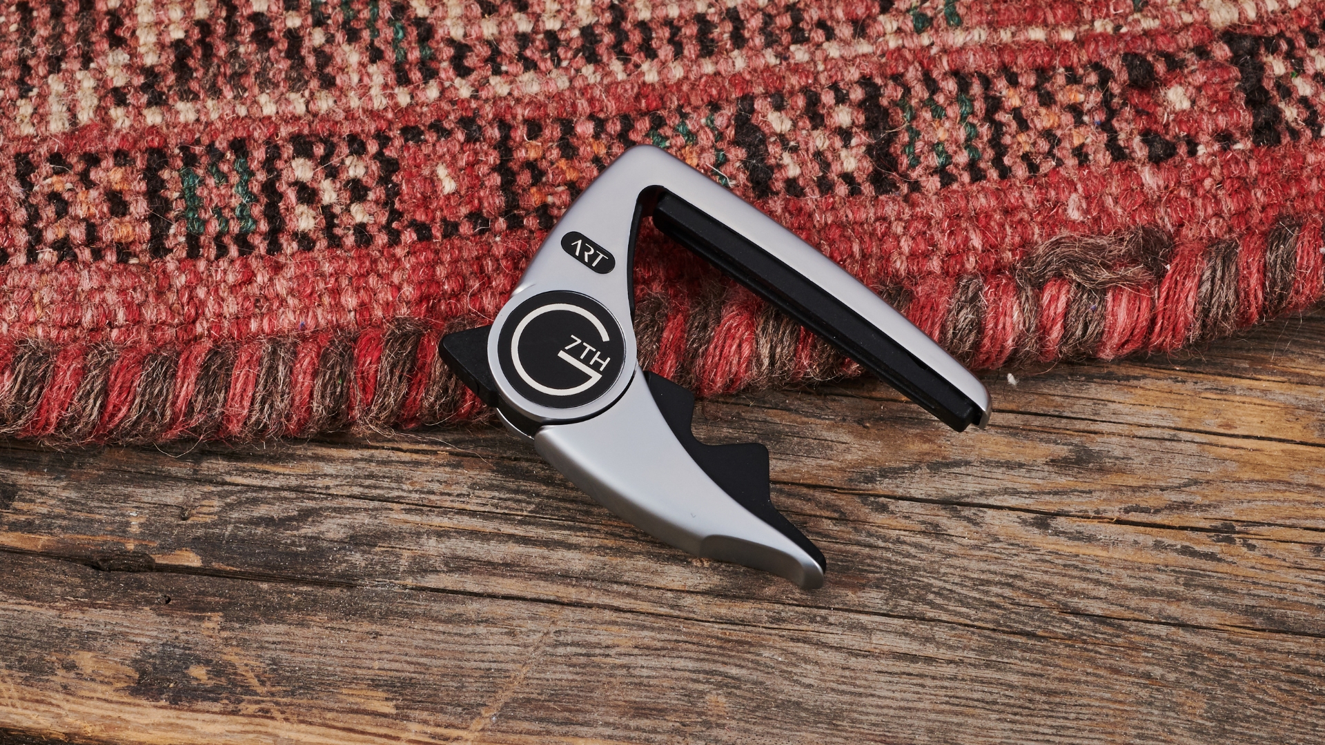 A G7th Performance 3 ART Capo lying partially on a rug