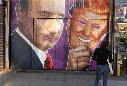 A mural depicting a winking Vladimir Putin taking off his Donald Trump mask in Brooklyn.