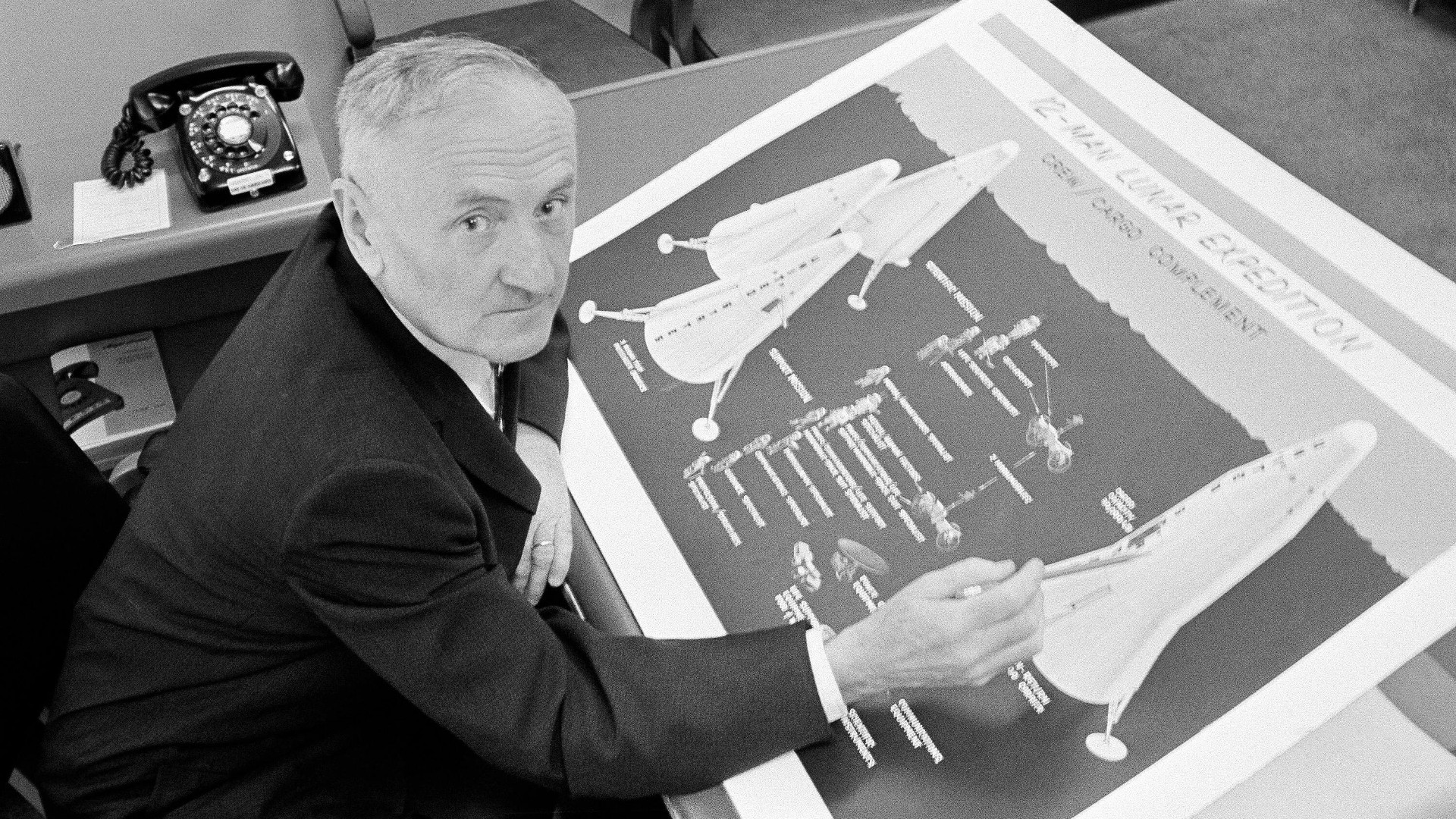 Dr. Fritz Zwicky looks up from his chart of lunar exploration space vehicles at the California Institute of Technology in Pasadena, Aug 21, 1961.