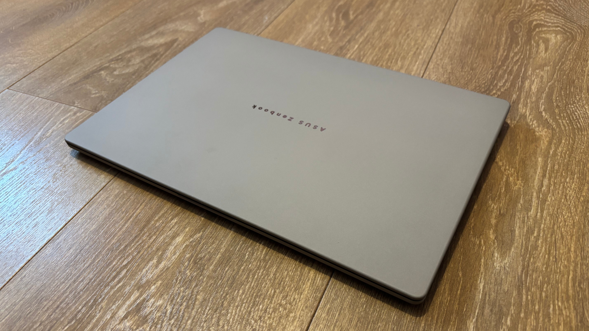 Asus Zenbook A14 with a closed lid resting on the floor