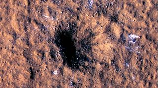 A freshly formed crater on the surface of Mars photographed by NASA's Mars Reconnaissance Orbiter