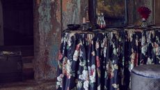 Black floral tablecloth in industrial-style dining room