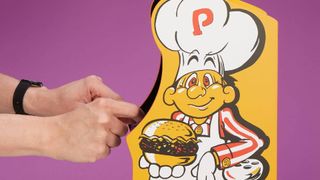 Close up of Quarter Arcades Burger Time side art with hands using controls.