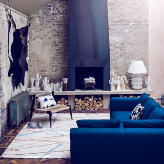 brick walls with fireplace carpet on flooring and sofa set with cushion
