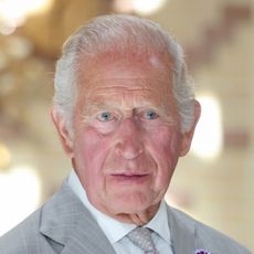King Charles wearing a light gray suit 
