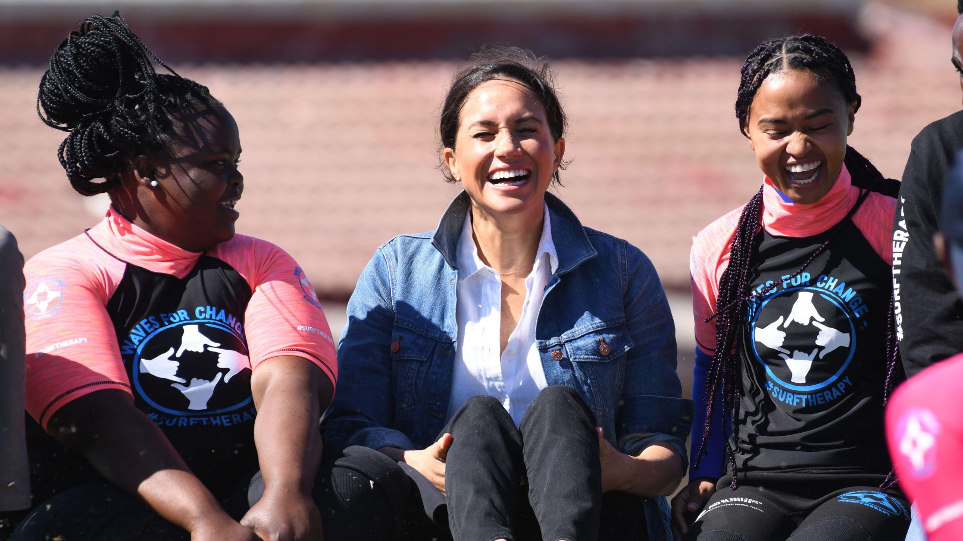 Meghan Sussex laughing with some teen girls