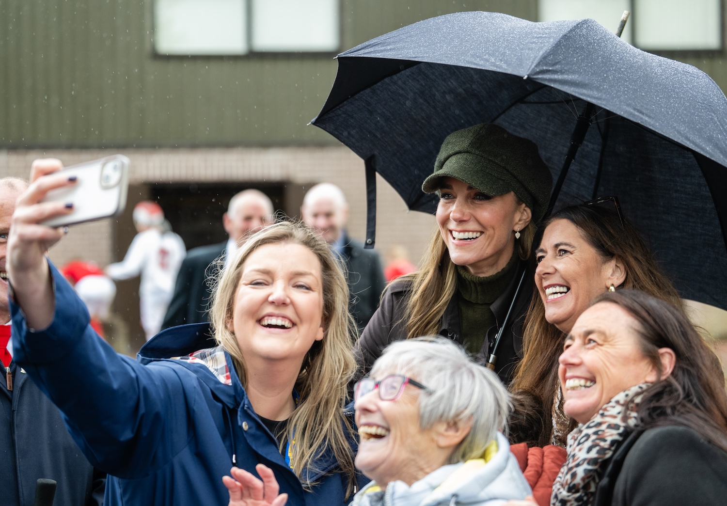 Princess Kate taking a selfie with four women under an umbrella
