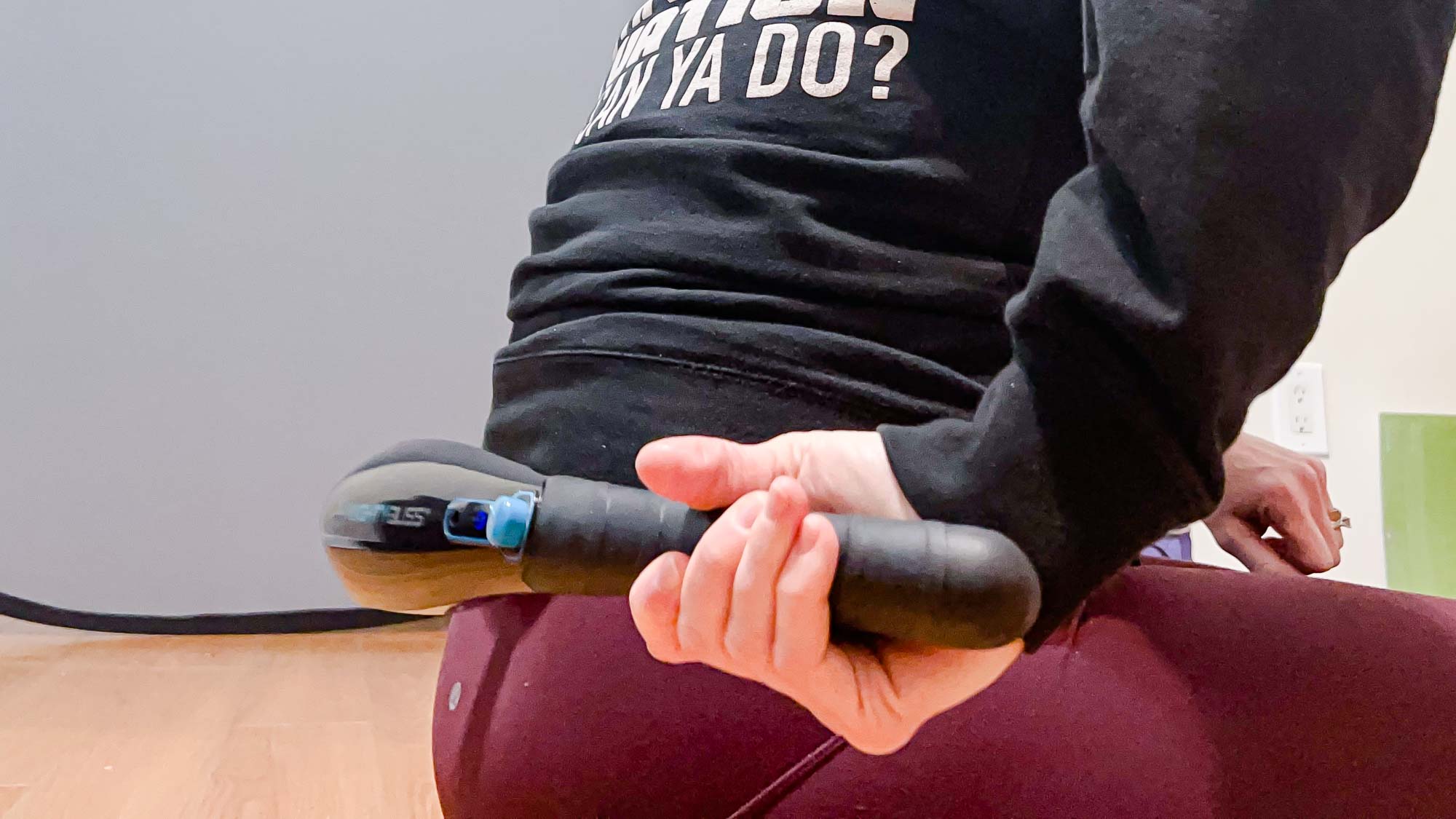 Mighty Bliss Cordless Massager in use on lower back