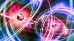 An illustration of two particles as glowing geodesic shapes surrounded be halos of pink, yellow and blue light