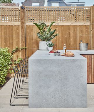 an outdoor kitchen with a worktop overhang bar