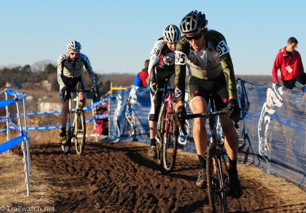Riders climb a muddy track in the 35-39 championship race