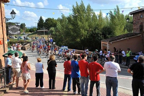 Fans watch as the race heads through their town.