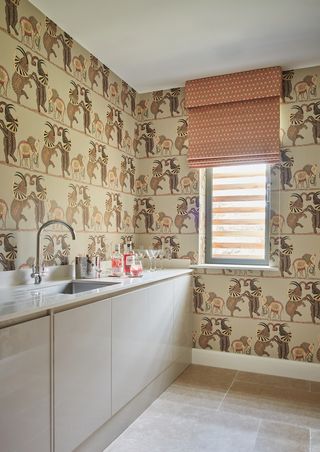 Wet bar in room with wallpaper and Roman blind