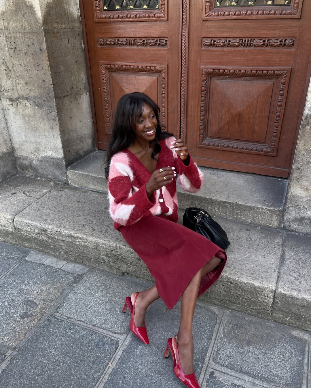 Emmanuelle in red, pink and white argyle cardigan
