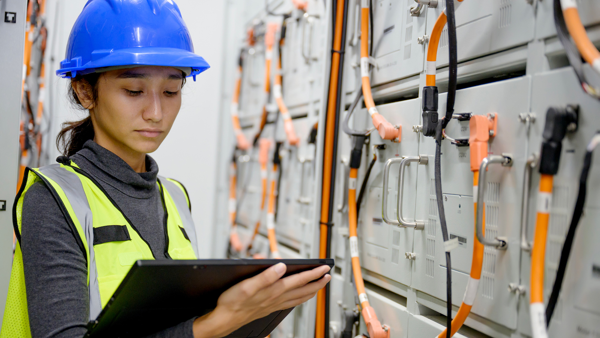 A technician inspecting a battery energy storage system (BESS).