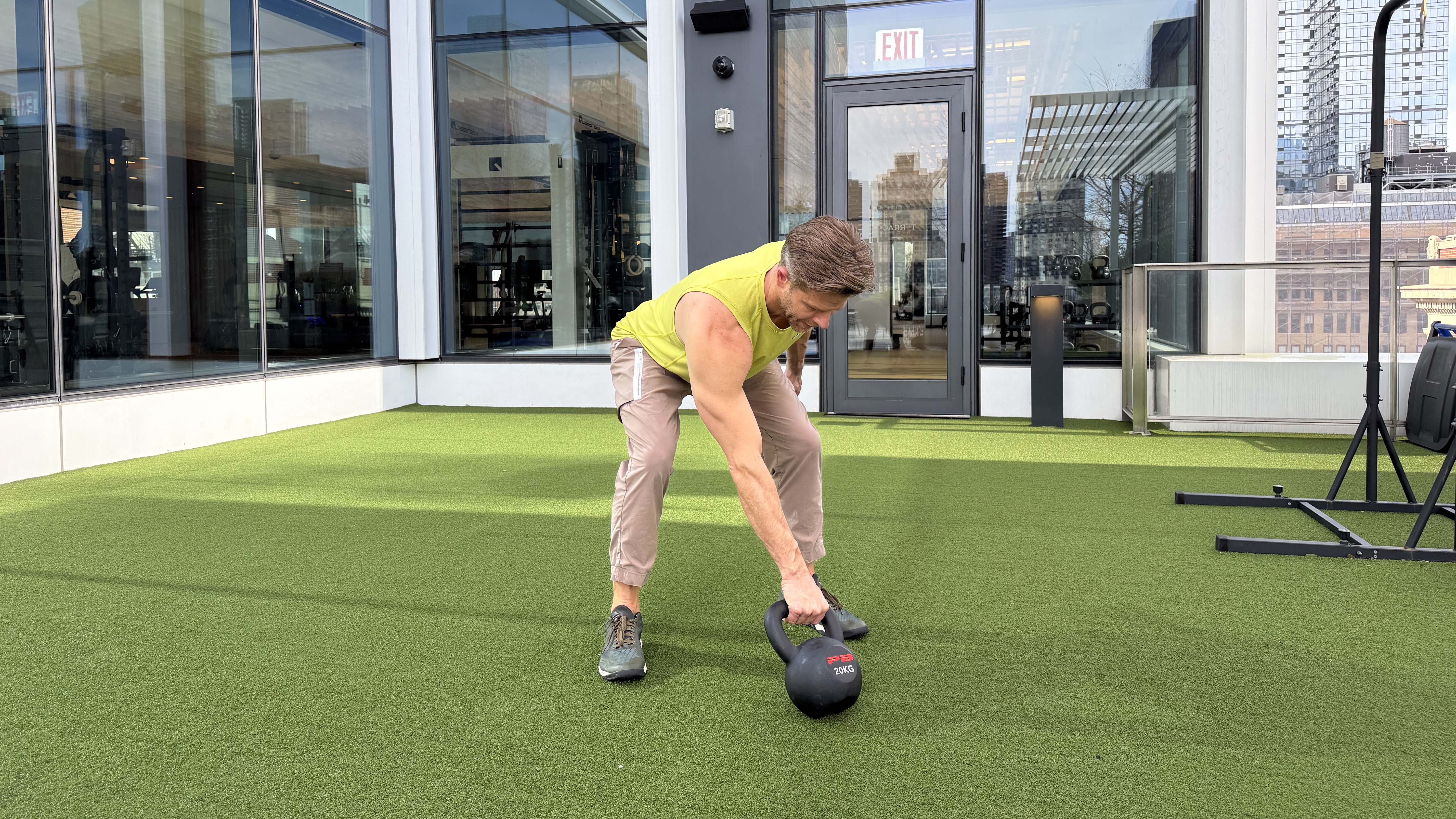 a photo of Peloton trainer Andy Speer doing a kettlebell swing