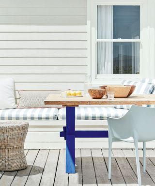 wooden outdoor table with legs painted a deep blue shade
