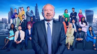 Lord Alan Sugar stood in front of "The Apprentice" season 18 candidates and a backdrop of London skyscrapers
