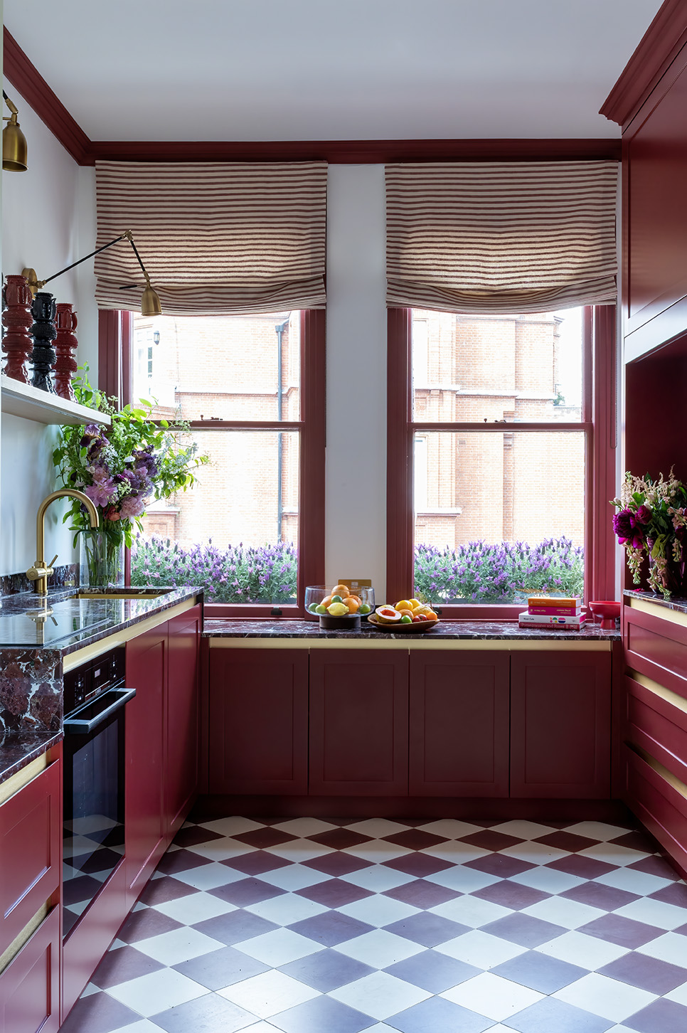 small red kitchen with checkerboard tile floors