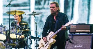 Billy Duffy performs onstage with the Cult
