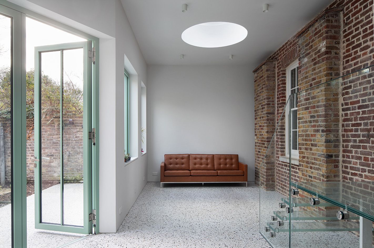 sofa in white room at the The Saddlery extension