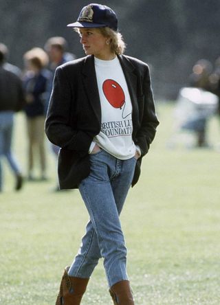 Princess Diana sporting a cap, simple t-shirt, blazer and jeans