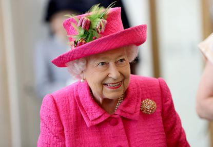 The Queen in a brightly coloured matching outfit 