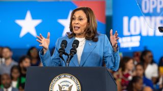 Democratic U.S. presidential candidate Vice President Kamala Harris, wearing a blue suit, speaks ahead of her address at the Democratic convention 2024