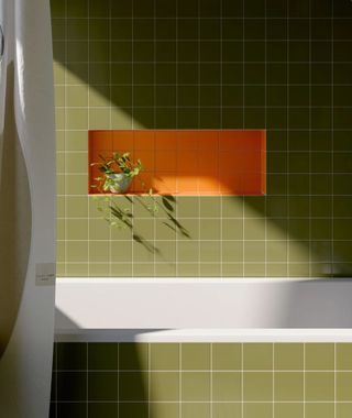 Green tiled bathroom with orange tiled storage nook