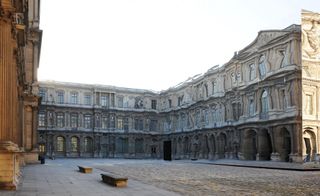 Exterior photo of the mirrored reflection of the courtly Cour Carrée building