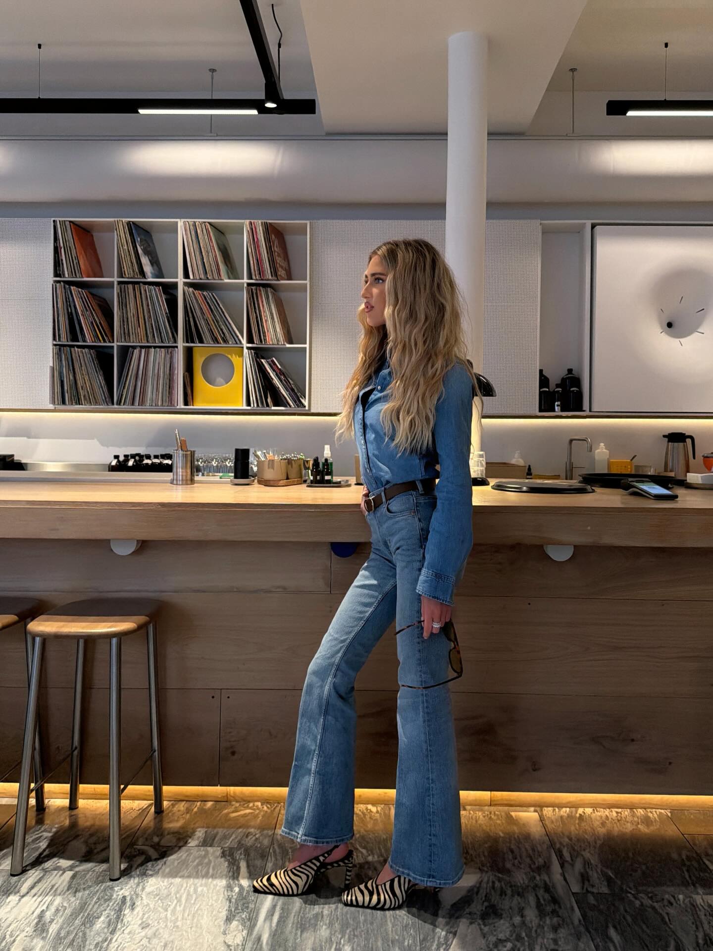 An image of a woman wearing denim shirt outfit 2026